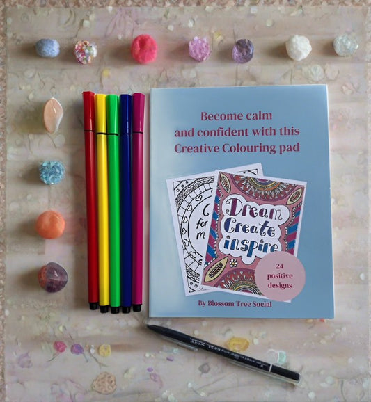 Colouring pad with pens and crystals at the side. Cover reads - become calm and confident with this creative colouring pad, 24 positive designs by Blossom Tree Social