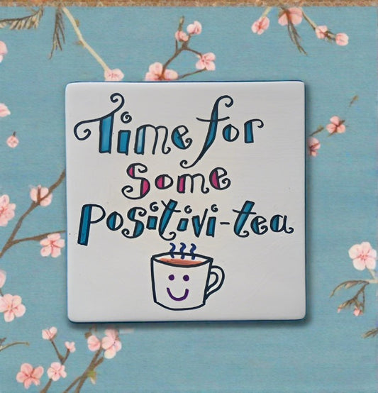 Ceramic coaster with writing on that reads - Time for some positivi-tea and a cup of tea drawing at the bottom